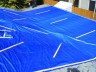 After - Flat roof tarped; tarp must extend up roof and over ridge